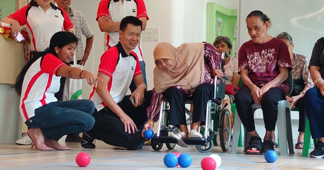 Corporate volunteers engaging seniors through a community activity